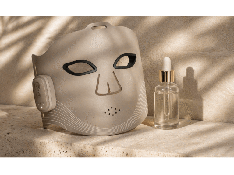 High-end wireless LED facial mask with serum on a stone surface, summer skincare tech photography